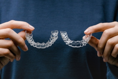 reveal clear aligners being held